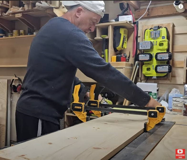 Working in the shop with clamps on the boards